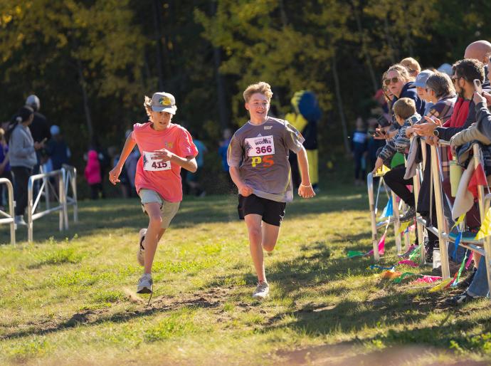 Two young athletes sprinting it out at the end of a race