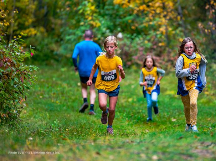 A group of young runners on the trails at the run for the wolves event