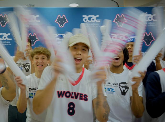 Wolves athletes cheering with noise makers at the Make Some Noise event