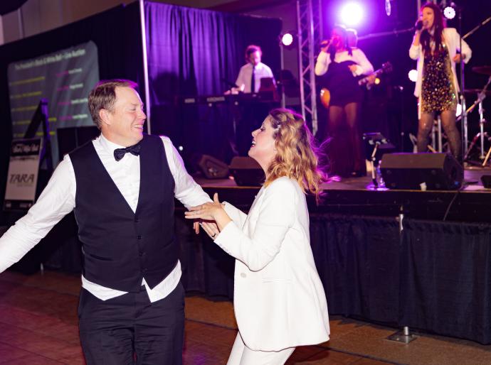 A lively couple enjoying a dance at the President's Ball event.