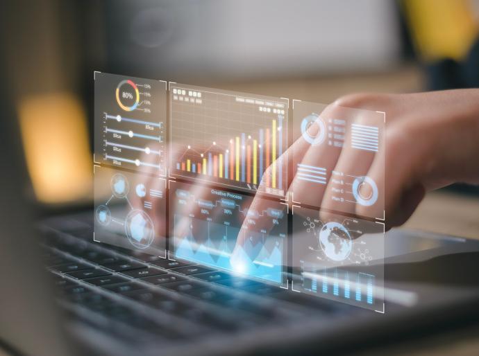 Data analyst working on business analytics dashboard with charts, metrics and KPI to analyze performance and create insight reports for operations management.