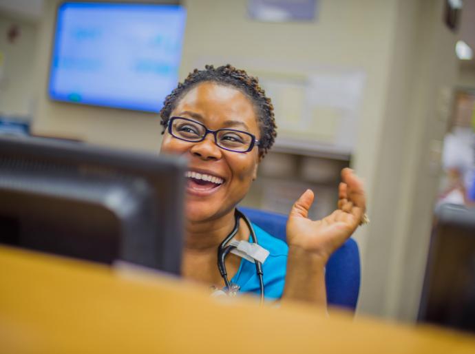 A happy staff member at the reception desk in a hospital