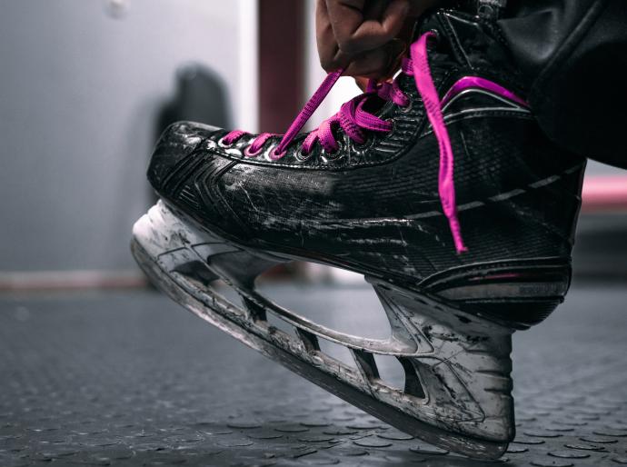 Close up of a hockey skate with pink ;laces
