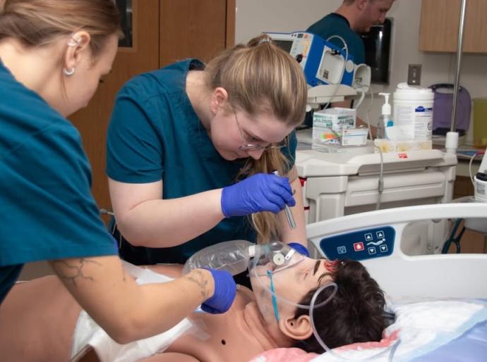 Students practicing on simulation mannequin