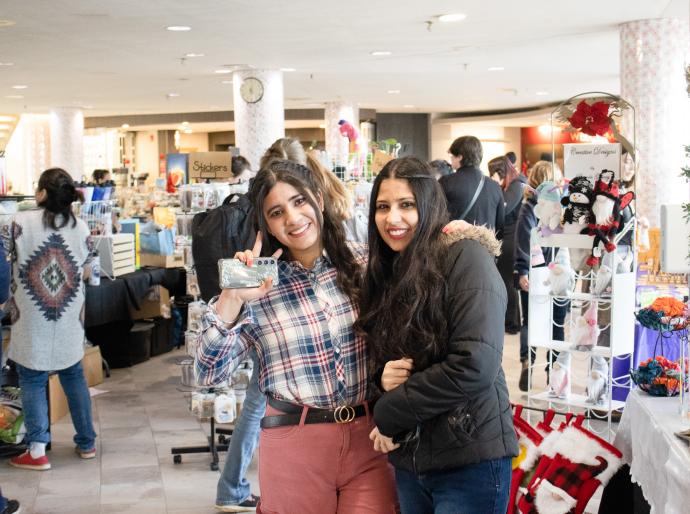 Happy customers at a craft show infront of vendor booths
