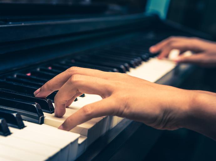 close up of a womans hands playing the piano
