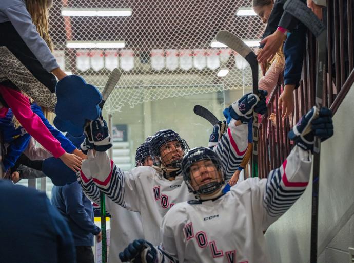 Womens hockey team leaving the ice after the second period of a winning game