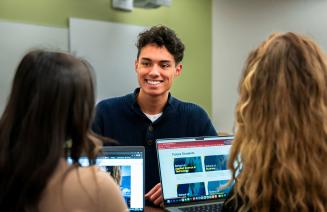 Students chatting at a computer station