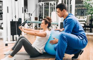 Exercise physiologist helping a client with rehabilitation