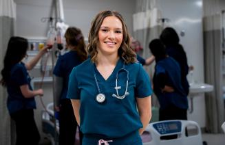 Student nurse posing in the simulation lab