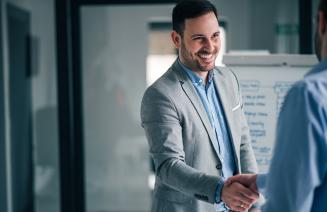Businessmen shaking hands in a board room