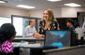 Woman at reception in a busy workplace