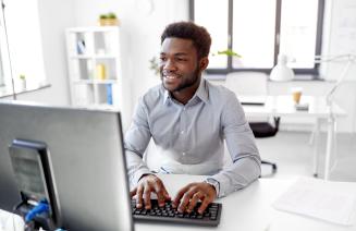 Man working at his desk typing on a keyboard