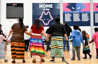 Dancers with colourful skirts holding hands at the Circle of Indigenous Students year end event