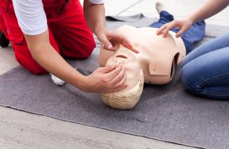 First aid student practicing technique on a dummy