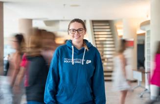 Proud NWP employee posing in a branded blue hoodie