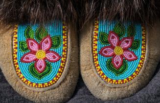 Close up of the colourful beadwork on a pair of moccasins.