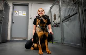 Veterinary technology student posing with a cute puppy