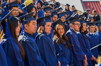 A group graduates smiling