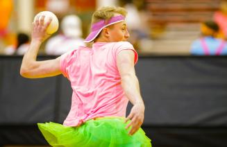 Student in brightly coloured clothing about to throw a dodgeball