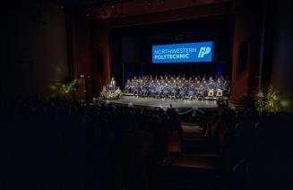 Birds eye view of the Fred Speckeen theatre full of graduates and their friends and family at convocation 2025