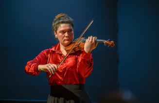 Julia Biegel playing violin on stage at the springtime sonata concert