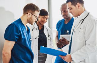 A group of young doctors reviewing a patients file