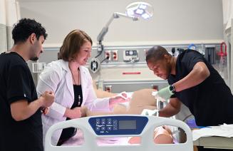 Practical nursing students receiving hands-on training in the simulation lab