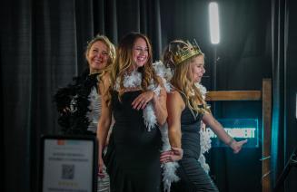 Guests wearing party accessories in a photo booth at the presidents ball