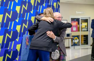 Long service award recipient sharing an embrace with the NWP President and CEO