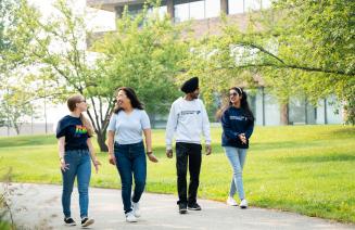 Students walking and chatting on a summers day on Grande Prairie Campus