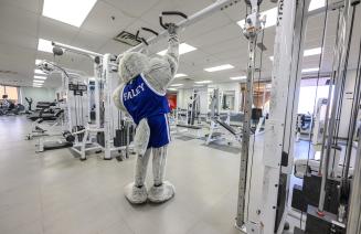 NWP wolves mascot Farley in the weight room on grande prairie campus
