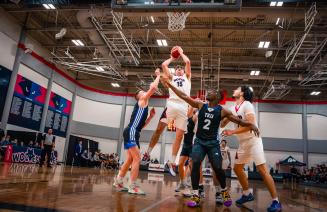 Men's basketball players battling it out at the hoop