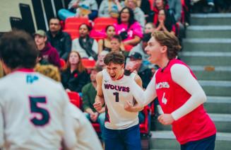 Wolves men's volleyball player celebrating after winning a point