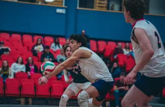 Mens wolves volleyball player receiving the ball