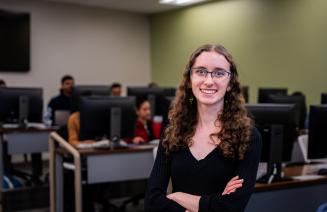 Happy student posing in the computer lab