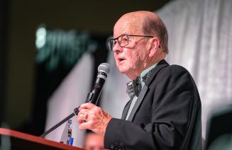 Community Alumni Award recipient, Fred Estlin at the microphone.