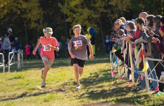 Two young athletes sprinting it out at the end of a race