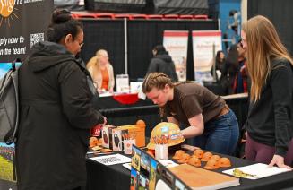 Vendors happily interacting with students at the Career Fair