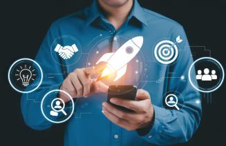 Businessman launching digital innovation with rocket and strategy icons.