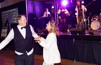 A lively couple enjoying a dance at the President's Ball event.