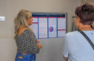 Student presenting a research presentation to interested attendees