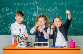 A group of children participating in a chemistry experiment involving test tubes