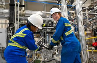 Two students working on power engineering equipment in an hands-on learning lab