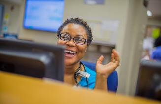 A happy staff member at the reception desk in a hospital