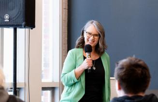 Smartly dressed professional woman delivering a keynote address