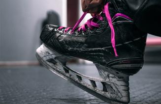 Close up of a hockey skate with pink ;laces
