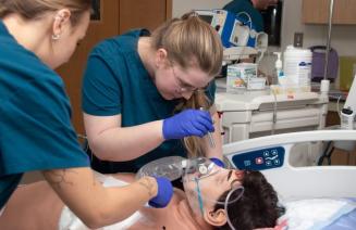 Students practicing on simulation mannequin