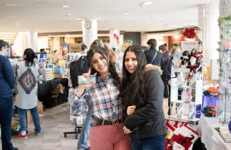 Happy customers at a craft show infront of vendor booths