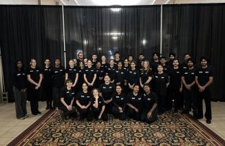 Volunteers pose in a group at the 2025 Presidents Ball